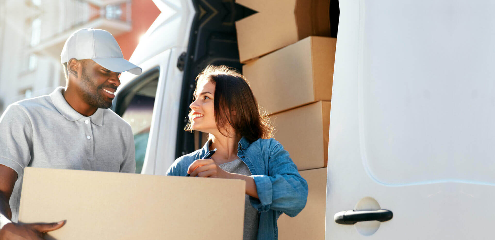 delivery man and woman smiling at each other