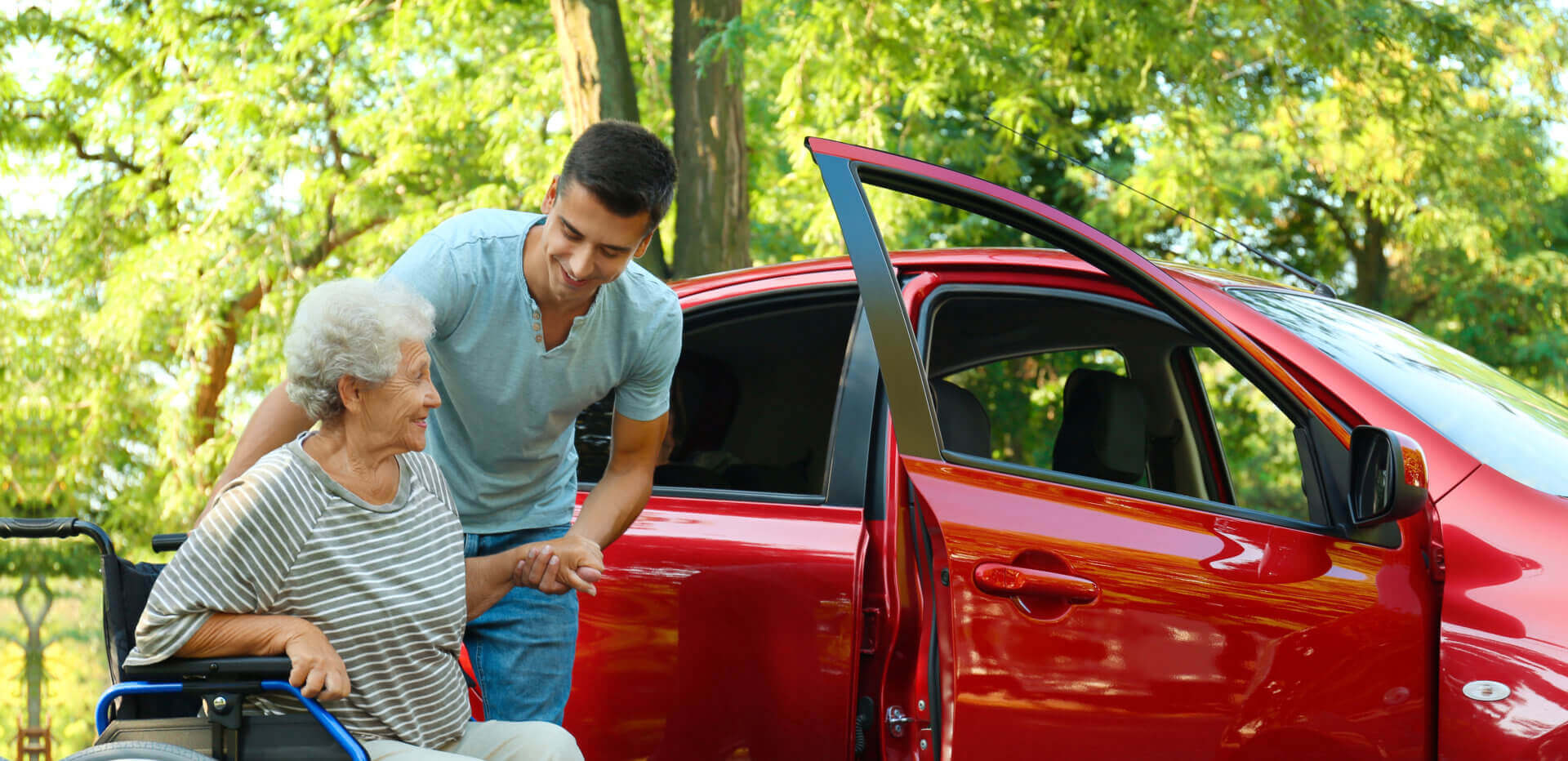 man assisting an elderly woman to get on the car