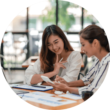 woman and man sitting while the man is pointing the screen of computer